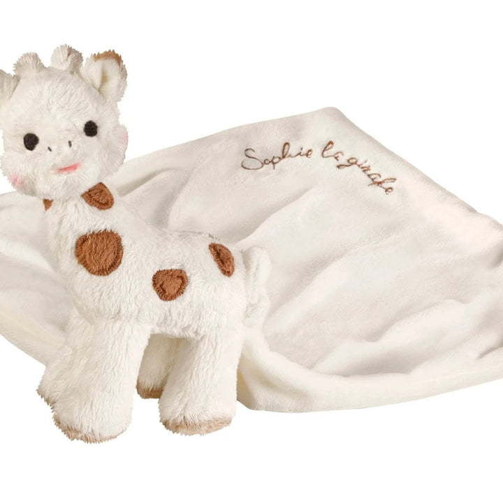Plush giraffe toy comforter in a gift box with 'Sophie la girafe' branding.