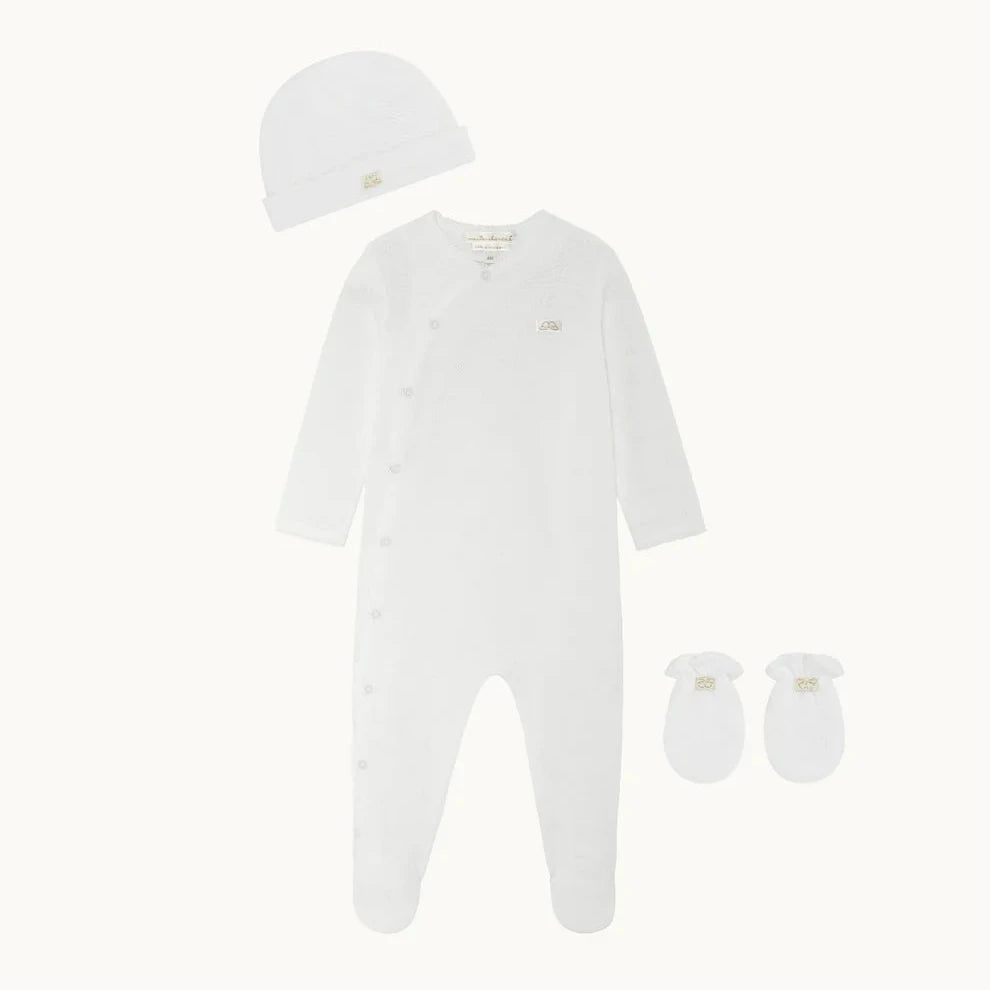 Made from 100% cotton and featuring our signature Angel Wing pointelle design, Marie-Chantal’s Pointelle Cotton Gift Set is a newborn must-have.
- Pointelle Cotton Sleepsuit
- Pointelle Cotton Hat And Mitten Gift Set
- Footed design
- Snap fastenings down the front