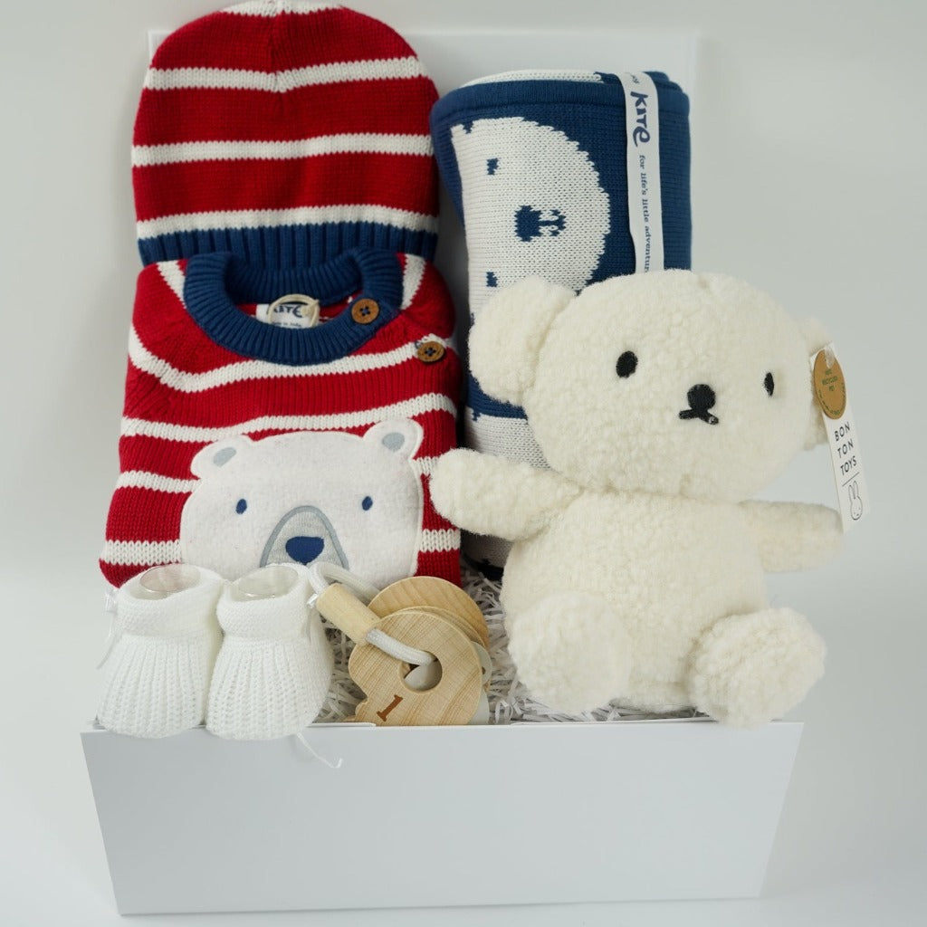 organic baby knit romper in red, cream and blue stripes, matching baby knit hat, Blue organic knit baby blanket with cream teddy face, recycled boris bear by Miffy , wooden teething baby keys