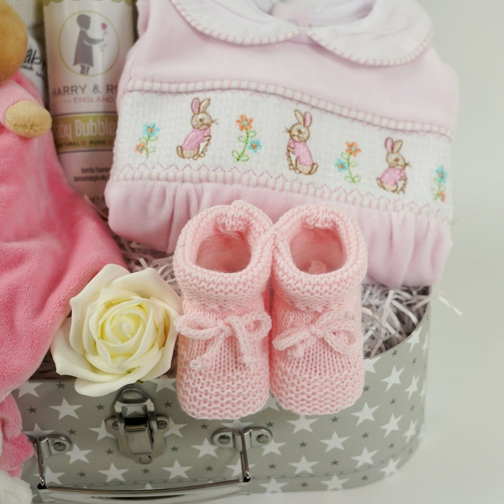 Baby girl hamper with flopsy bunny comforter in pink and white, baby cellular blanket, baby milestone cards , cute pink velour baby sleepsuit with smocked front with flopsy bunny, pink knit booties , baby organic wash