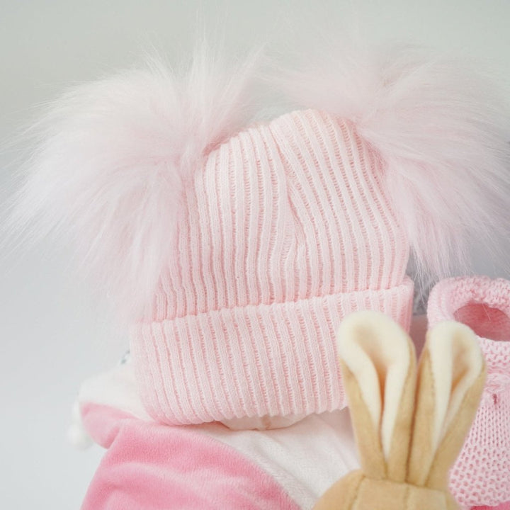 small white hamper box with beatrix potter pink bunny comforter with knot ends , pink booties and pink double pompom fluffy
