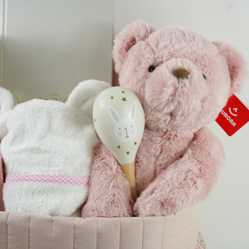 pink fairy floral quilted storage basket, reversible, white with pink flowers swaddle, white baby dressing gown with cute ears and pink and white gingham trim, bassinette quilt in pink, mama notes pregnancy diary, bump luxury mum candle, pink soft teddy, pink and grey maracas