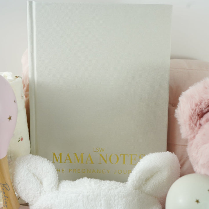 pink fairy floral quilted storage basket, reversible, white with pink flowers swaddle, white baby dressing gown with cute ears and pink and white gingham trim, bassinette quilt in pink, mama notes pregnancy diary, bump luxury mum candle, pink soft teddy, pink and grey maracas