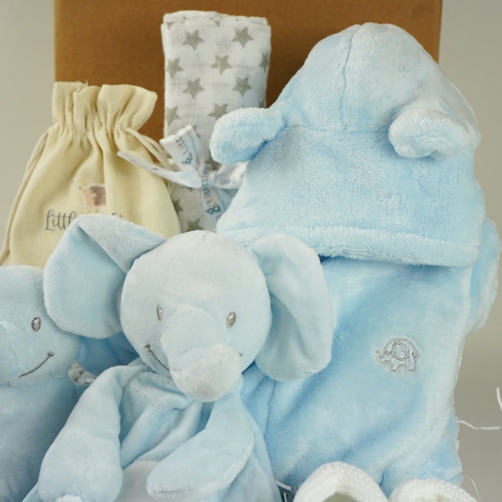 blue baby boy hamper , blue bunny comforter, blue soft bunny toy, baby dressing gown with cute ears, white booties, wooden memorable moment discs, baby muslin