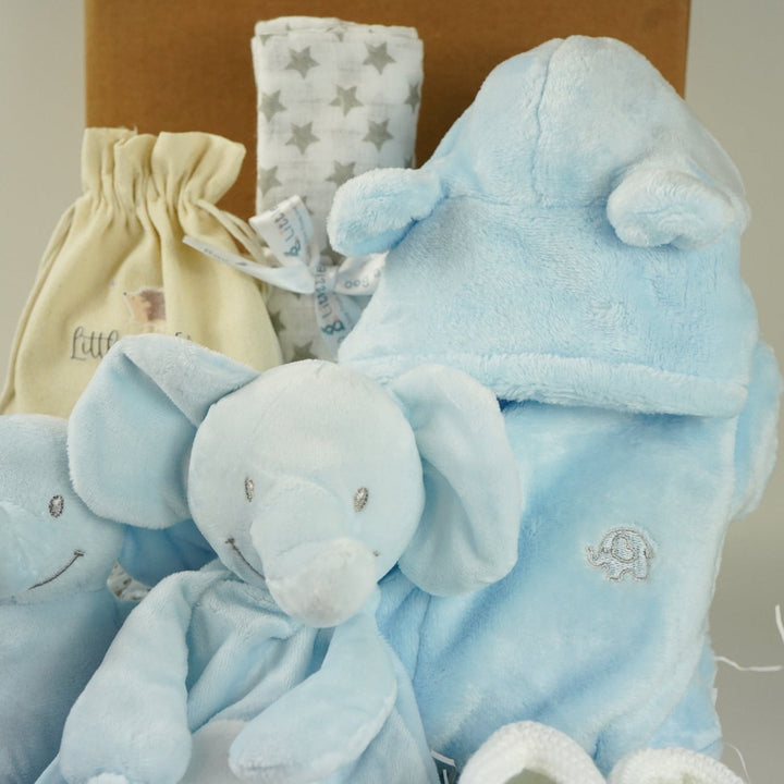 blue baby boy hamper , blue bunny comforter, blue soft bunny toy, baby dressing gown with cute ears, white booties, wooden memorable moment discs, baby muslin