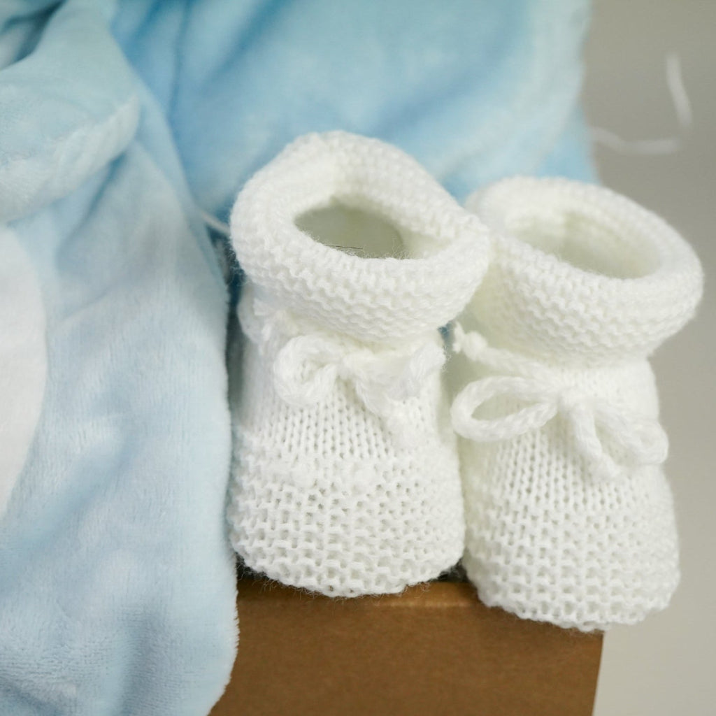 blue baby boy hamper , blue bunny comforter, blue soft bunny toy, baby dressing gown with cute ears, white booties, wooden memorable moment discs, baby muslin