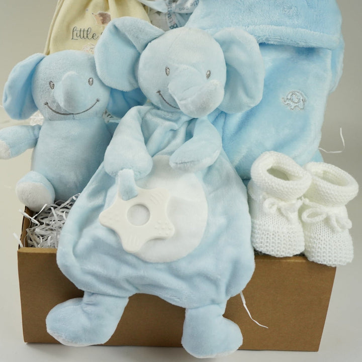blue baby boy hamper , blue bunny comforter, blue soft bunny toy, baby dressing gown with cute ears, white booties, wooden memorable moment discs, baby muslin