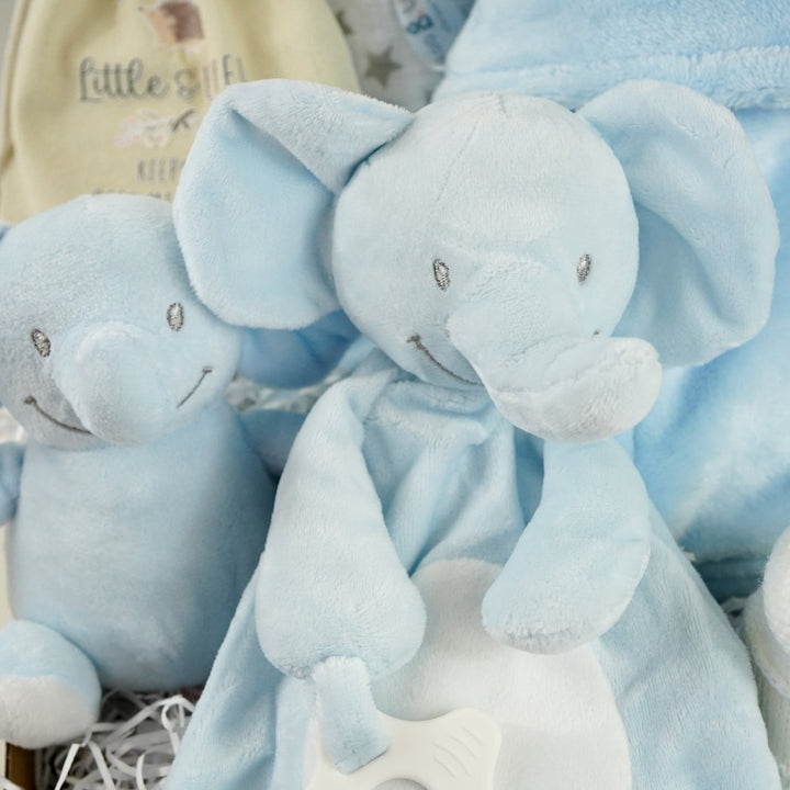 blue baby boy hamper , blue bunny comforter, blue soft bunny toy, baby dressing gown with cute ears, white booties, wooden memorable moment discs, baby muslin
