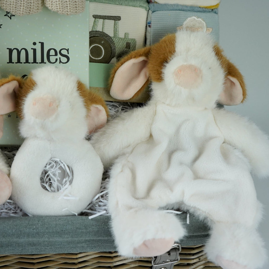 cow themed baby hamper with cow soft toy, comforter and rattle, farmyard soft blocks , baby milestone cards soft biscuit coloured hooded bath towel and knitted booties