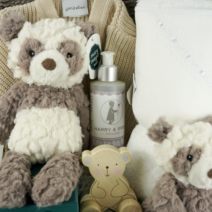 neutral baby hamper with grey and white panda soft teddy and matching baby comforter, cute white baby booties with ears and face, baby wooden push along toy,  baby toiletries, soft hooded towel