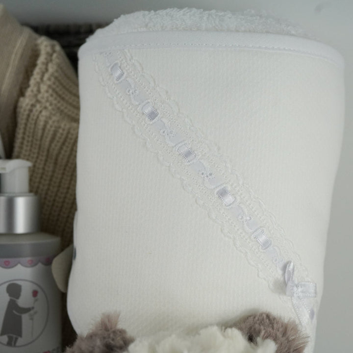 neutral baby hamper with grey and white panda soft teddy and matching baby comforter, cute white baby booties with ears and face, baby wooden push along toy,  baby toiletries, soft hooded towel . mum candle gift