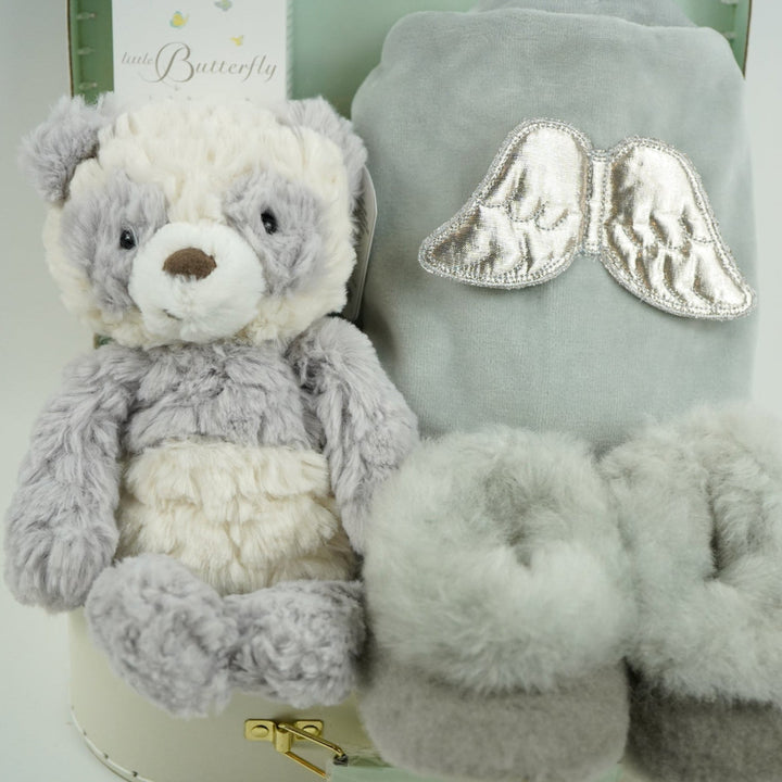 luxury neutral baby hamper in luxury baby keepsake suitcase in pale green with velour angel wings sleepsuit, organic baby toiletries, soft grey alpaca baby slippers and grey and white soft panda toy