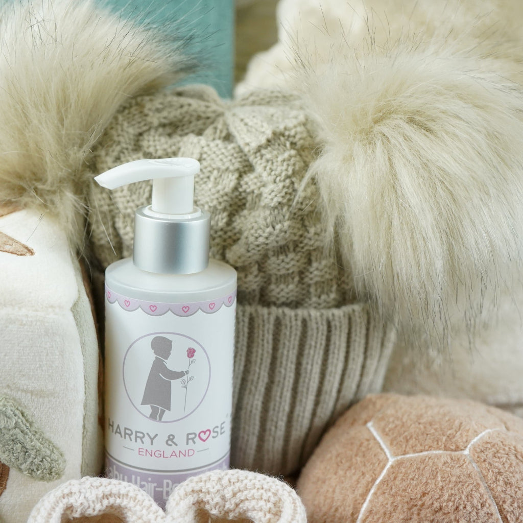 neutral baby hamper with baby dressing own, booties , baby journal, fluffy double pom pom hat, activity cube in neutral green, brown and cream with turtle, star fish and seahorse , soft turtle rattle toy