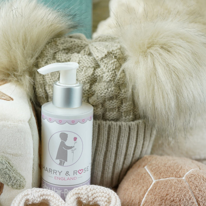 neutral baby hamper with baby dressing own, booties , baby journal, fluffy double pom pom hat, activity cube in neutral green, brown and cream with turtle, star fish and seahorse , soft turtle rattle toy