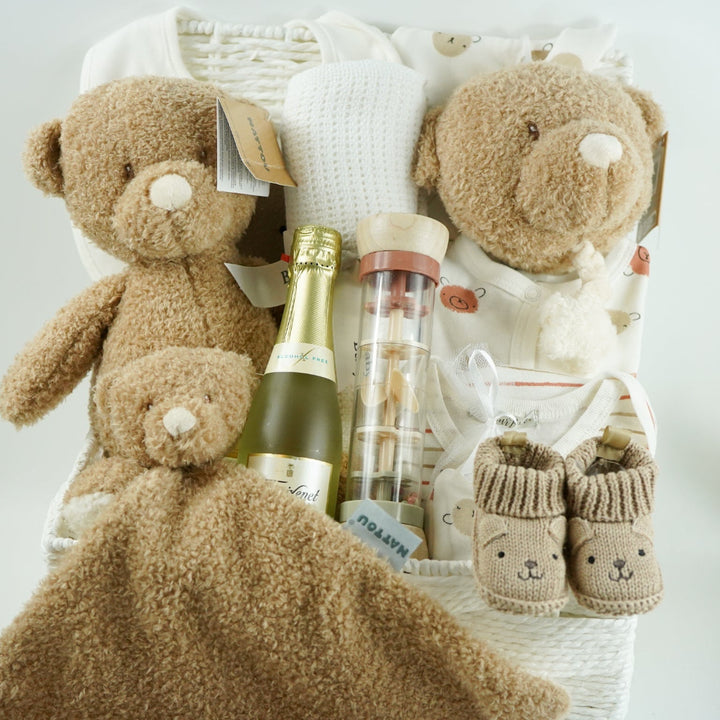 teddy themed baby hamper with teddy and matching comforter and musical teddy, cream with teddy face layette set, no alcohol frixenet , cellular blanket, baby booties and wooden ended rain maker