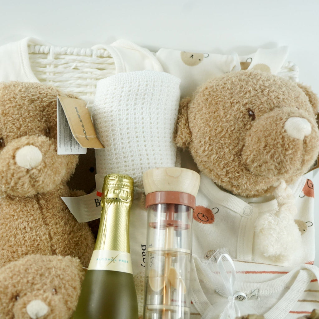 teddy themed baby hamper with teddy and matching comforter and musical teddy, cream with teddy face layette set, no alcohol frixenet , cellular blanket, baby booties and wooden ended rain maker