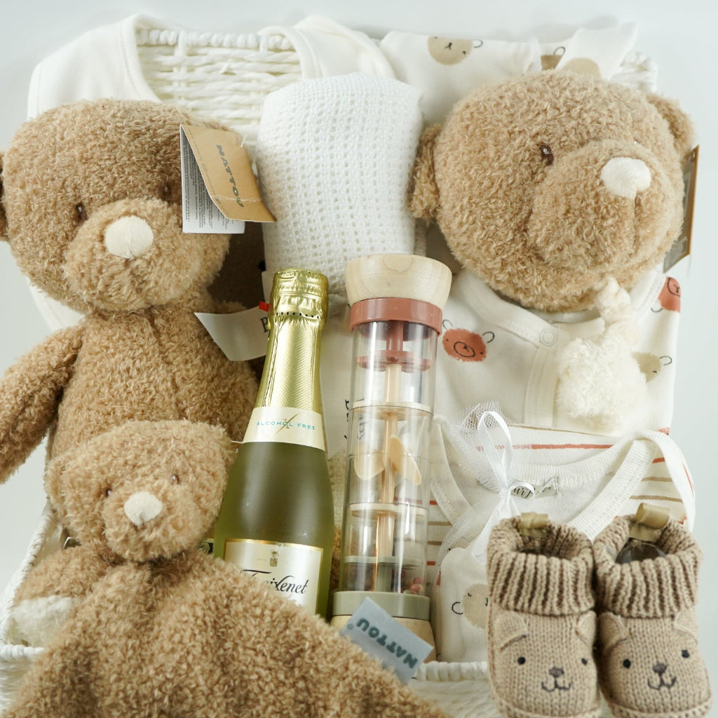 teddy themed baby hamper with teddy and matching comforter and musical teddy, cream with teddy face layette set, no alcohol frixenet , cellular blanket, baby booties and wooden ended rain maker