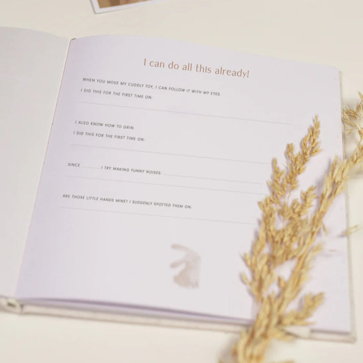 baby's first year book in white and cream