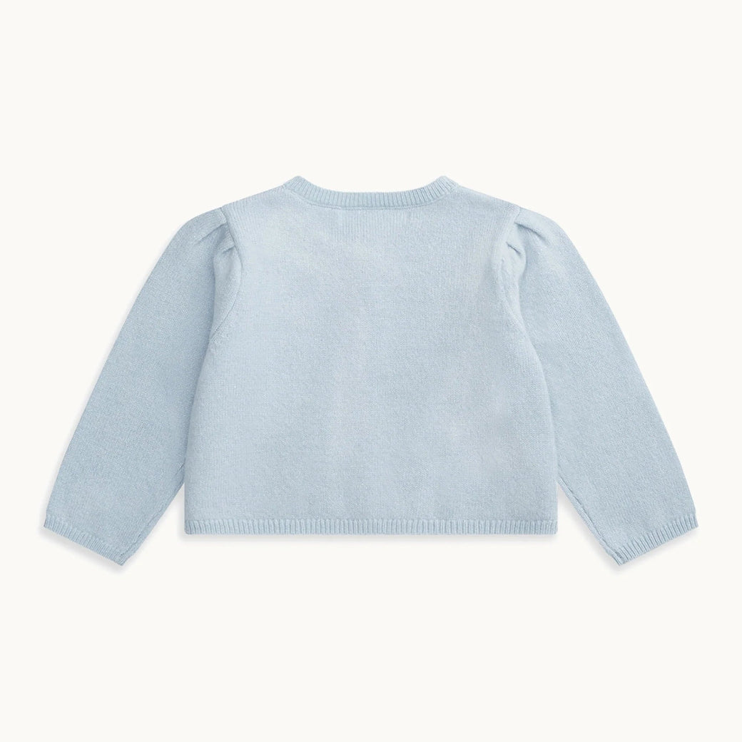Made from the softest cashmere, the Cashmere Sparkle Cardigan in pale blue is the perfect layering piece for your little one's wardrobe.
-Model wears size 6M 
-Fits true to size with slight stretch
-Blue button fastening 
-Pleated shoulder detail
-Rib trim on the collar, cuff and hemline.
