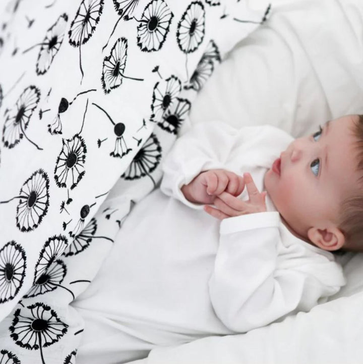 white and black baby sensory muslin with black dandelions