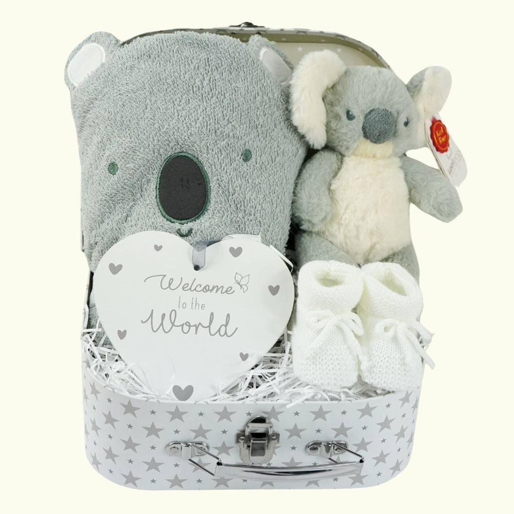 decorative suitcase with baby gifts includes a koala face grey hooded bath towel, Koala soft toy, white knit booties , nursery plaque