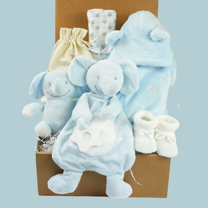 blue baby boy hamper , blue bunny comforter, blue soft bunny toy, baby dressing gown with cute ears, white booties, wooden memorable moment discs, baby muslin