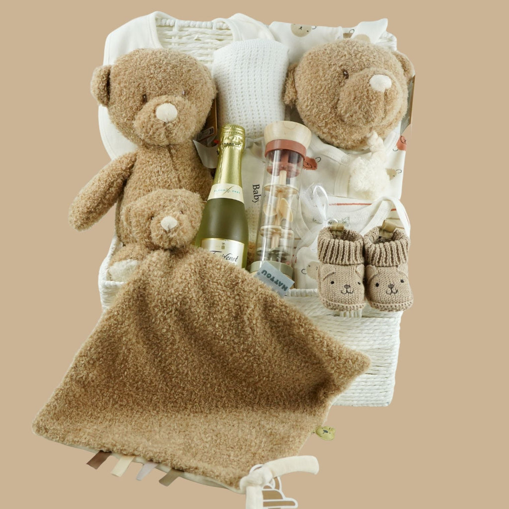 teddy themed baby hamper with teddy and matching comforter and musical teddy, cream with teddy face layette set, no alcohol frixenet , cellular blanket, baby booties and wooden ended rain maker
