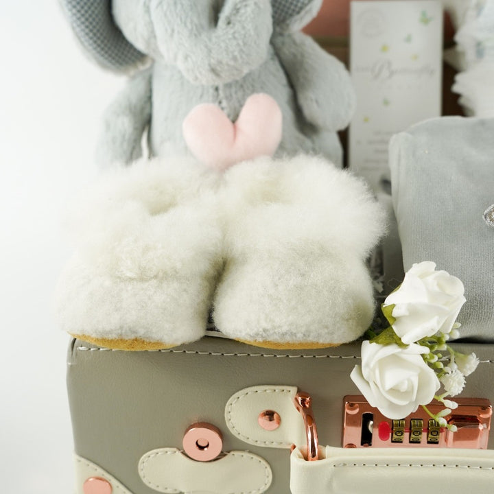 Grey baby suitcase with Steiff grey musical elephant, white alpaca wool baby slippers , grey with silver angel wings baby velour sleepsuit, baby handprint set