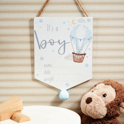 its a boy plaque in flag shape with pom pom on the tip, space to write baby stats