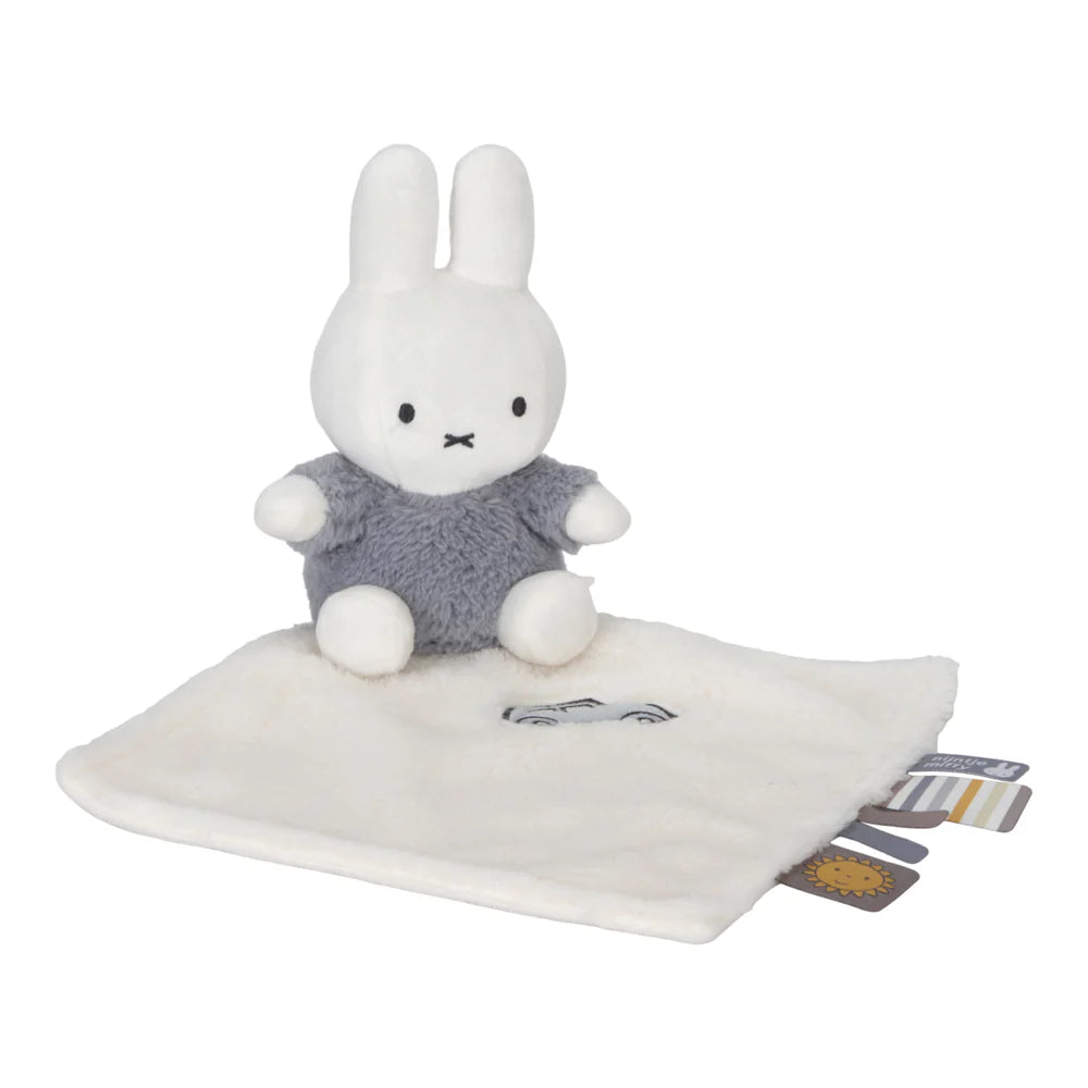 White miffy baby comforter , miffy sitting on cloth in blue fluffy outfit , taggies