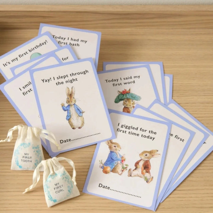 Peter rabbit gift keepsake box full of peter rabbit gifts including a blue peter rabbit comforter, soft toy and rattle, peter rabbit milestone cards