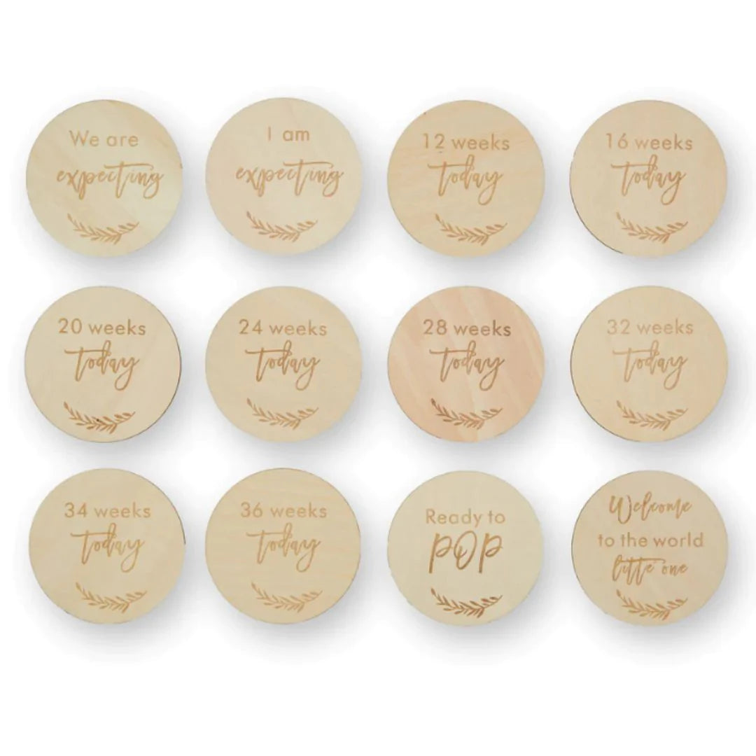 Pregnancy milestone discs in a cream drawstring bag