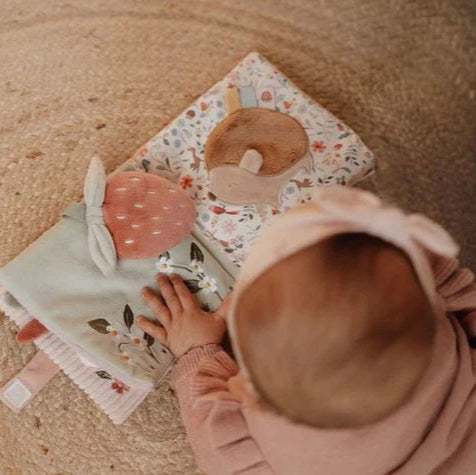 Pink soft baby sensory book with deer and fairy garden theme, full of pastel pink and green interactive images  and baby mirror