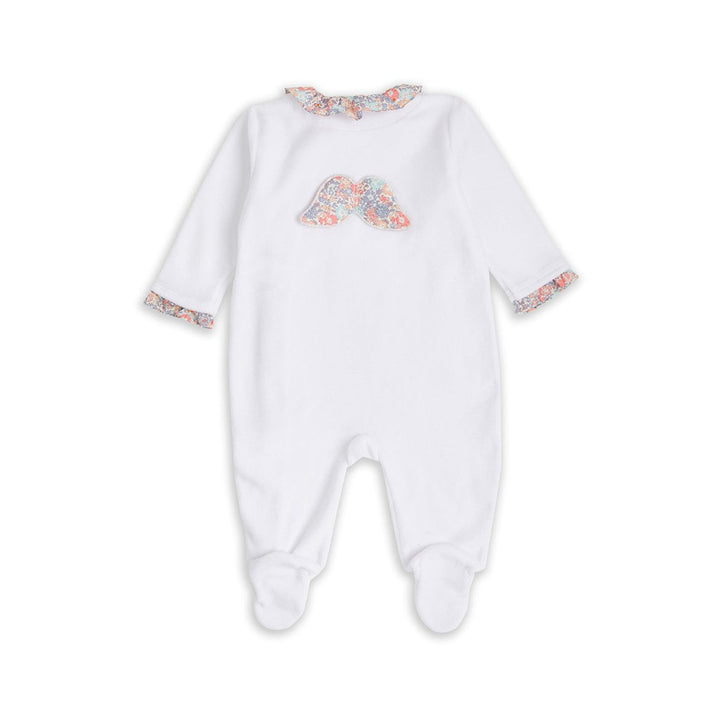 White velour baby sleepsuit with liberty print ruffle collar and libertiy print wings and trims around the cuffs, the sleepsuit is a soft velour