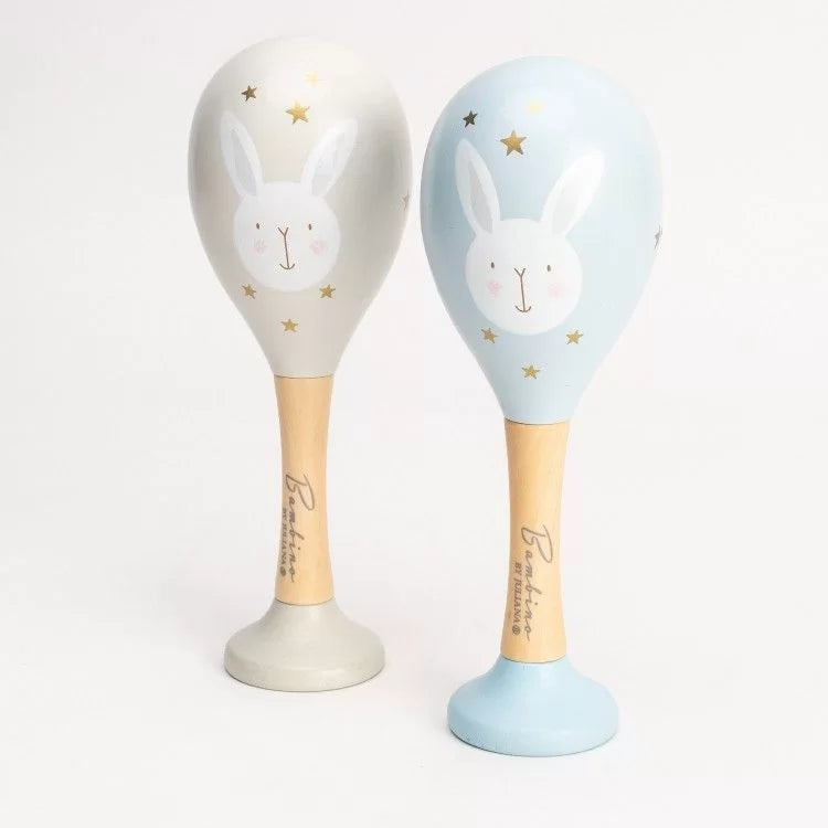 2 maracs for baby, one in blue with a white rabbit design and gold stars, one in grey with a white rabbit and gold stars, made from wood