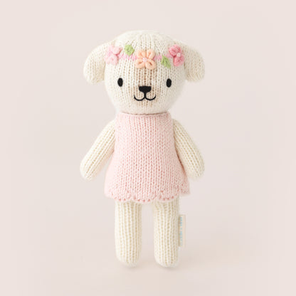tiny Charlotte white knitted dog soft toy in a pink dress with flowers in her hair 