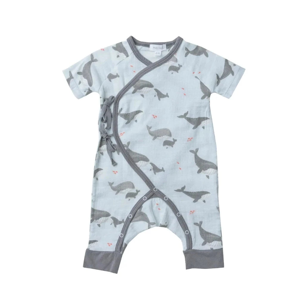 organic baby romper with pale  blue background and  grey whales, crossover tied 