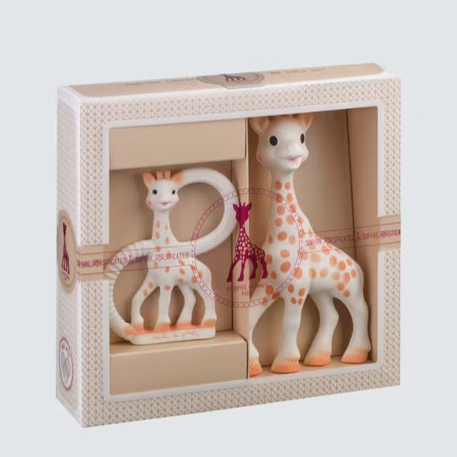 Set of giraffe-themed toys in a decorative box on a light gray background