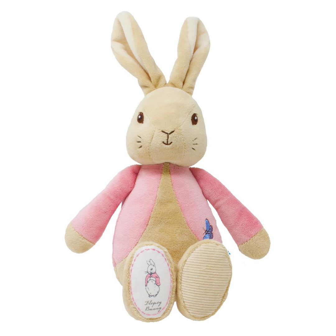 A plush rabbit toy with long beige ears, a cream face and belly, pink sleeves and side panels, and small embroidered blue and pink details, photographed on a plain white background.