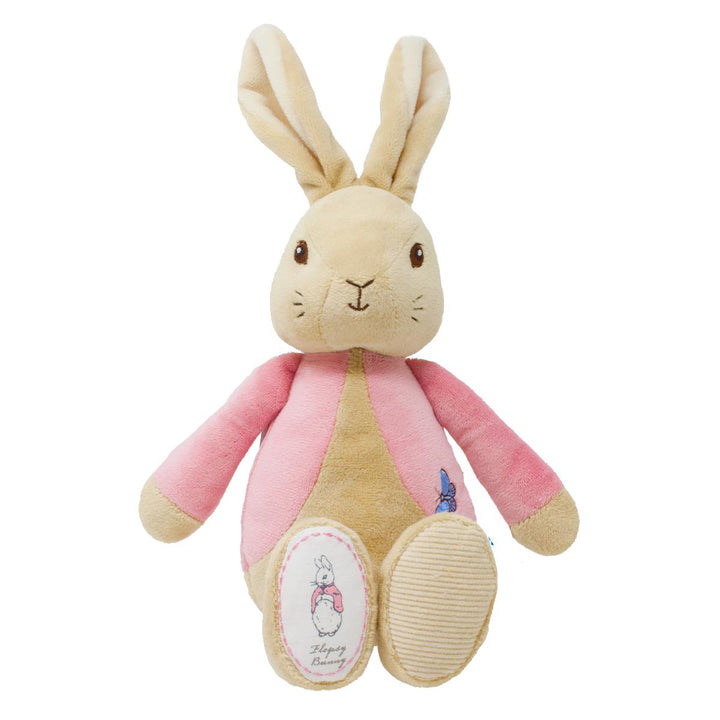 A plush rabbit toy with long beige ears, a cream face and belly, pink sleeves and side panels, and small embroidered blue and pink details, photographed on a plain white background.