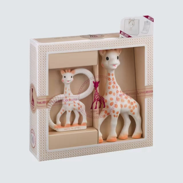 Two giraffe toys in a decorative box on a light gray background