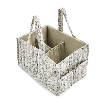 fabric nappy caddy with useful compartments in a white and neutral green with leaves and vines design