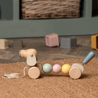 wooden sausage dog pull along toy in pastel colours