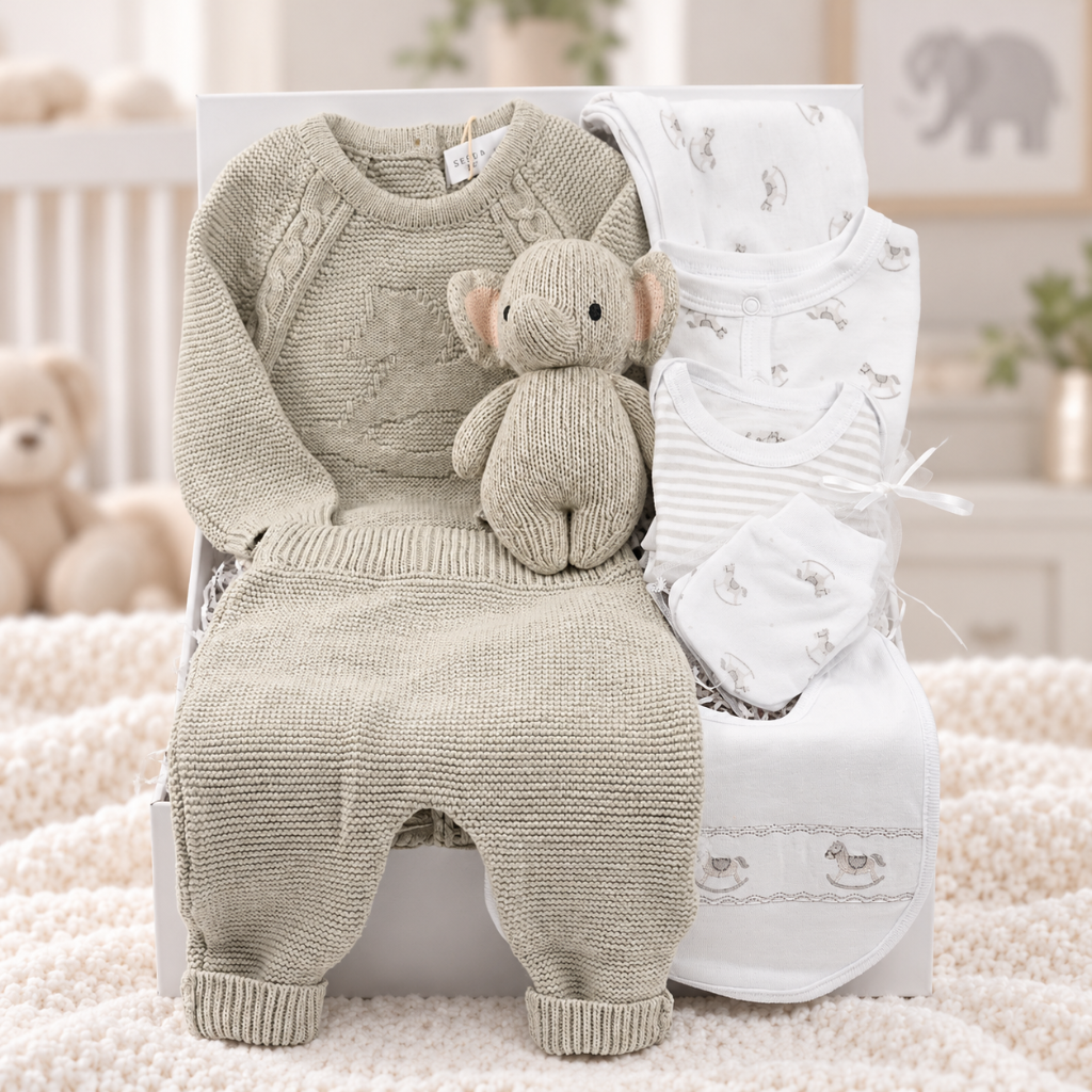 luxury baby hamper box includes a 2 piece cotton knit luxury baby 2 piece outfit with rocking horse design, 5 piece white cotton baby layette with rocking horse design, Cuddle + Kind knit elephant