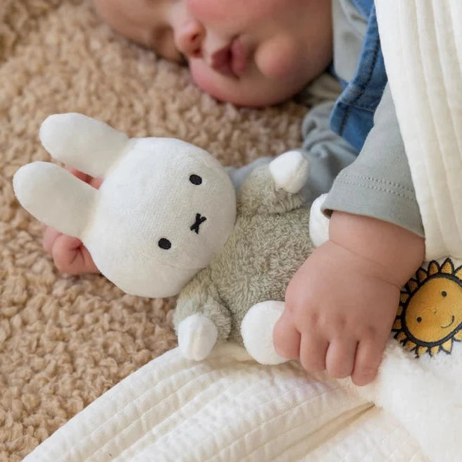 white Miffy cuddle cloth with white Miffy in green fluffy outfit and taggies