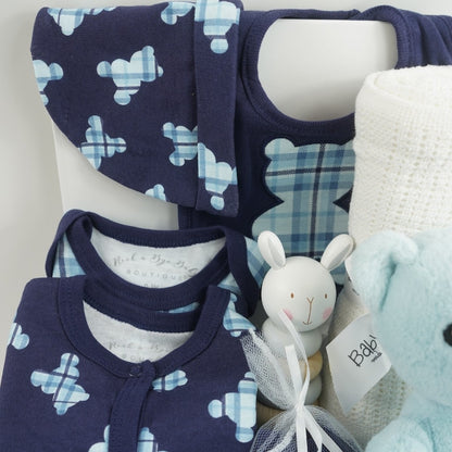baby boy hamper includes blue layette baby clothing set in navy with tartan teddy pattern in lighter blue, blue knit booties, my first steiff teddy in blue with button in ear, wooden stacking toy, teddy dimple fleece baby comforter, white cellular blanke