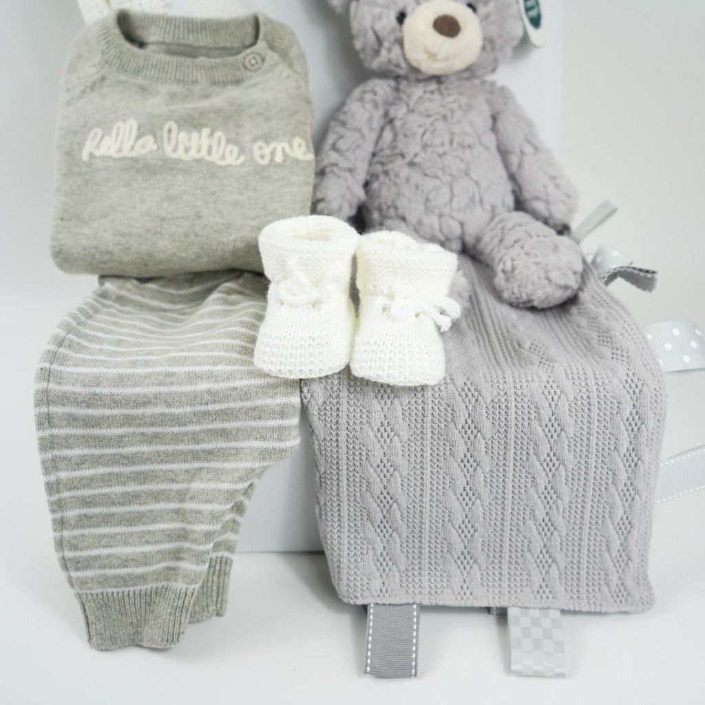 neutral baby hamper, grey and white fine knit baby 2 piece outfit, , white cellular knit blanket, grey teddy bear, white knit booties, grey knit taggie blanket, nursery plaque