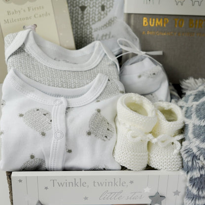 neutral baby hamper, baby clothing set in white with grey teddy faces, baby milestone cards, baby booties, bump to baby journal 
