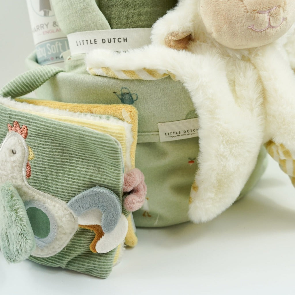 Little dutch farm basket in pale green, green little dutch blanket and farm green and plae green baby muslin, Harry and Rose organic baby lotion, Farm animals pram book in green, Lamb comforter and lamb soft toy