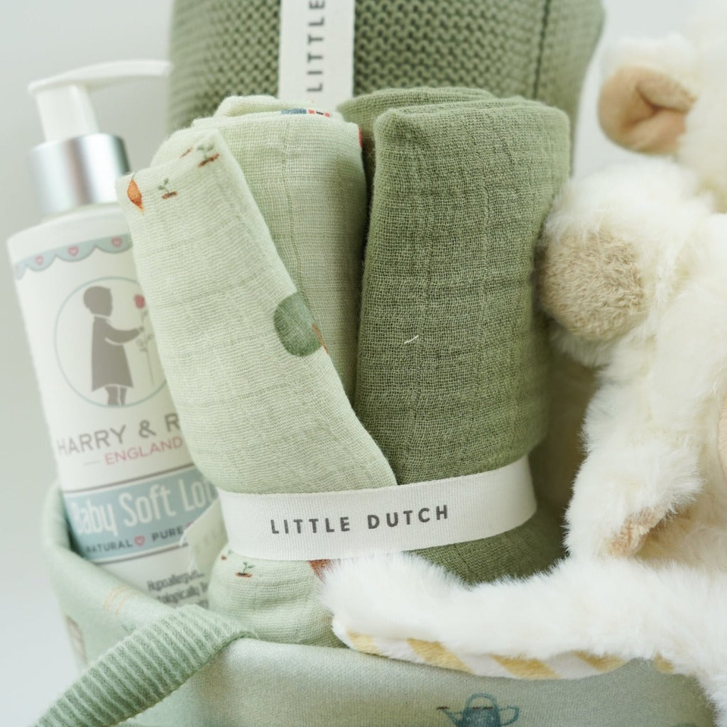 Little dutch farm basket in pale green, green little dutch blanket and farm green and plae green baby muslin, Harry and Rose organic baby lotion, Farm animals pram book in green, Lamb comforter and lamb soft toy